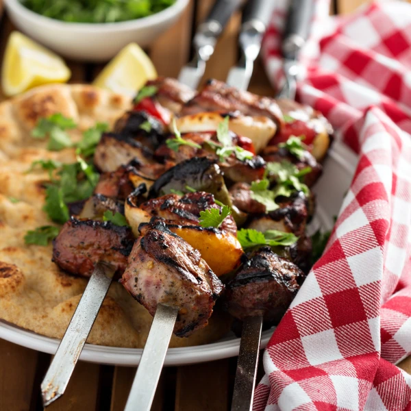 Lamb Kebabs Lamb kebabs with flatbread and tzatziki sauce.